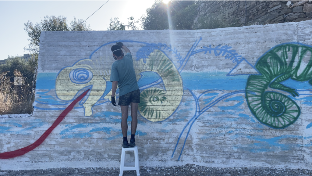 Niko Abramidis working on its mural